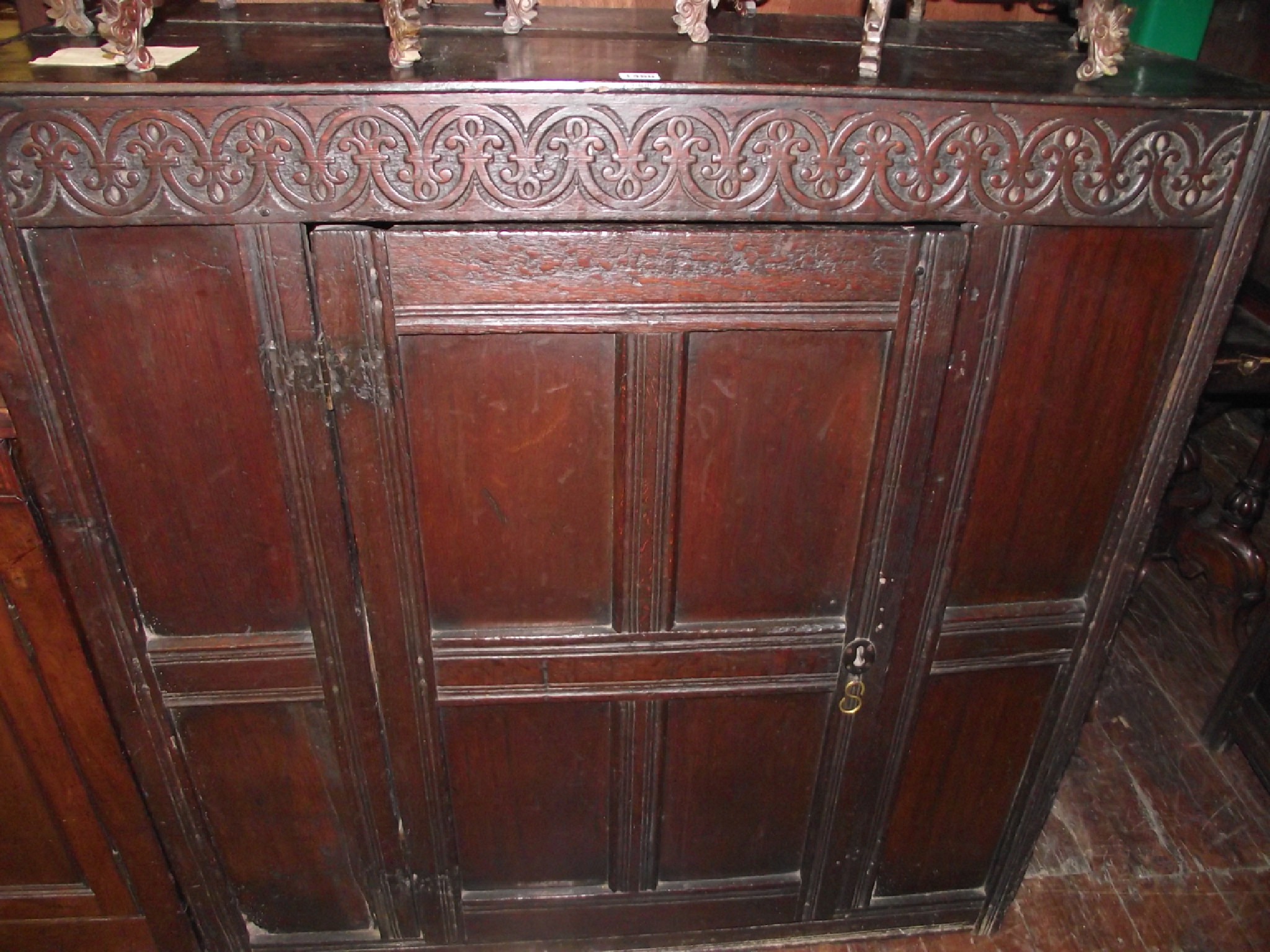 Appraisal: An th century oak cupboard with panelled framework and carved