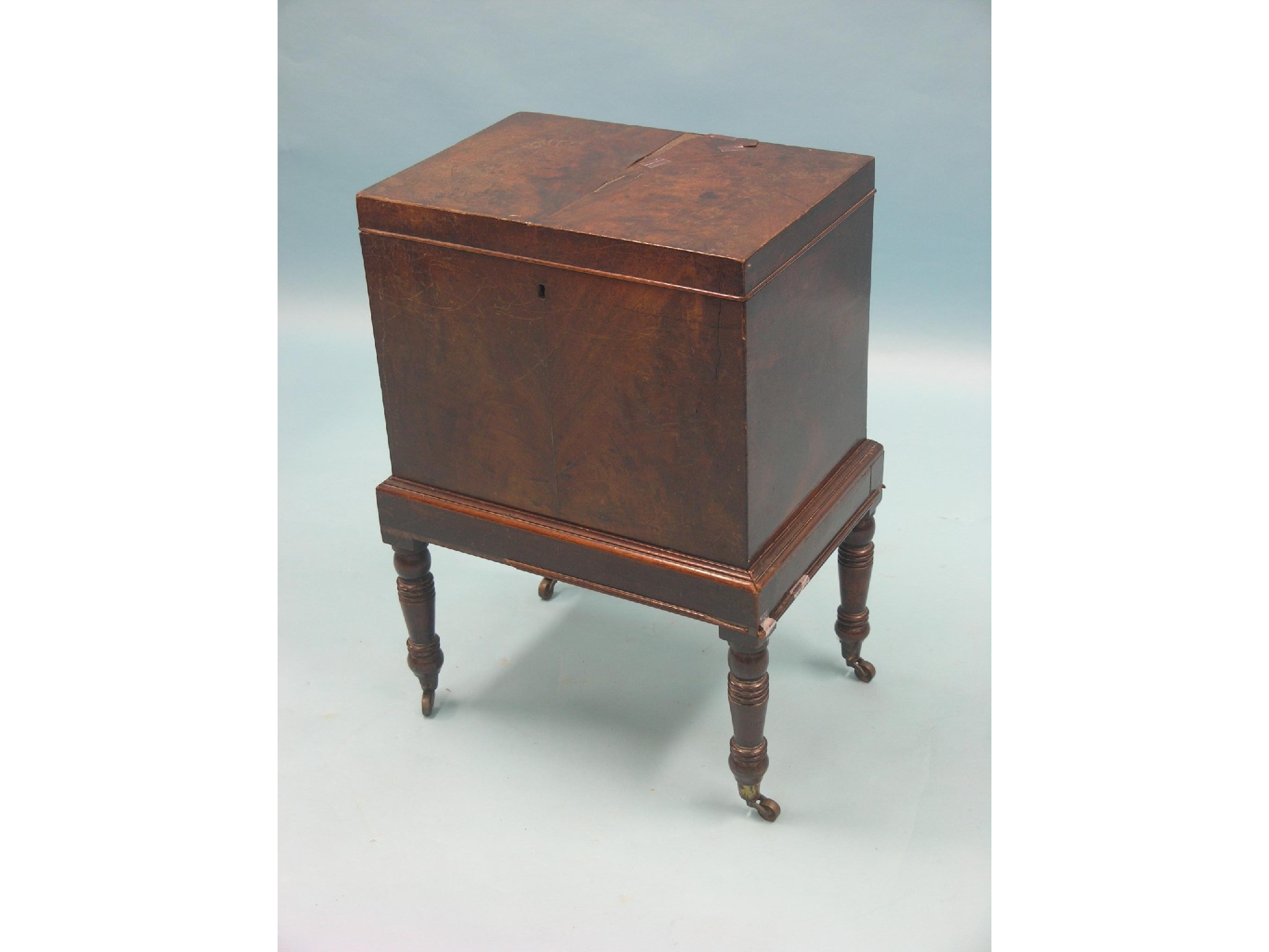 Appraisal: A late Georgian mahogany cellarette flame-veneered on turned legs with