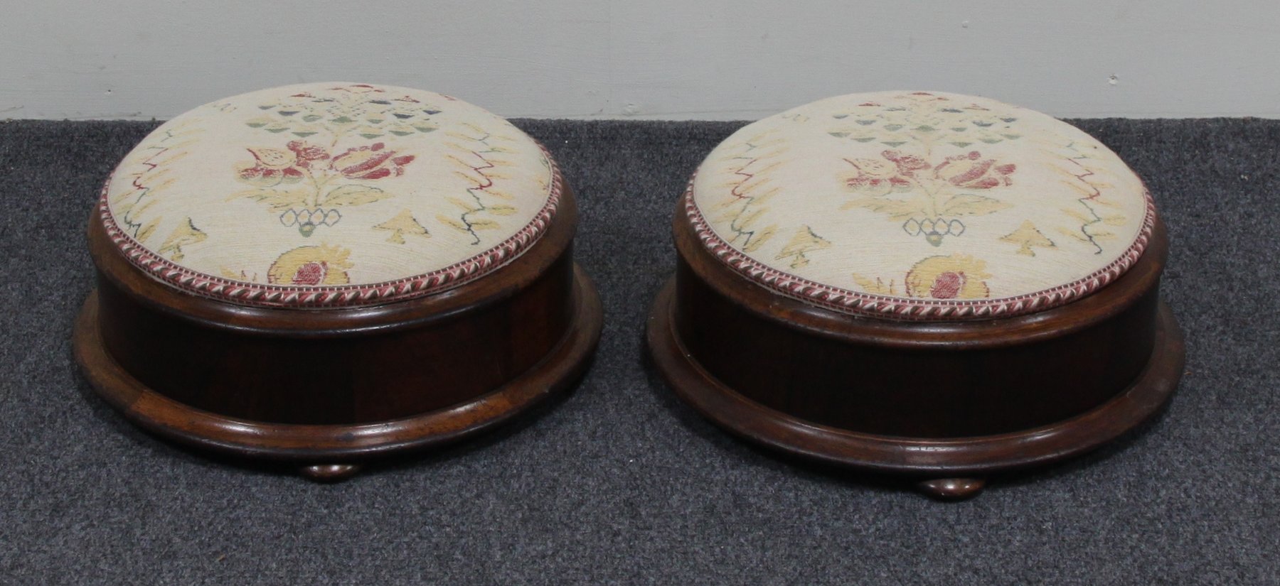 Appraisal: A pair of Victorian rosewood footstools each of circular shape