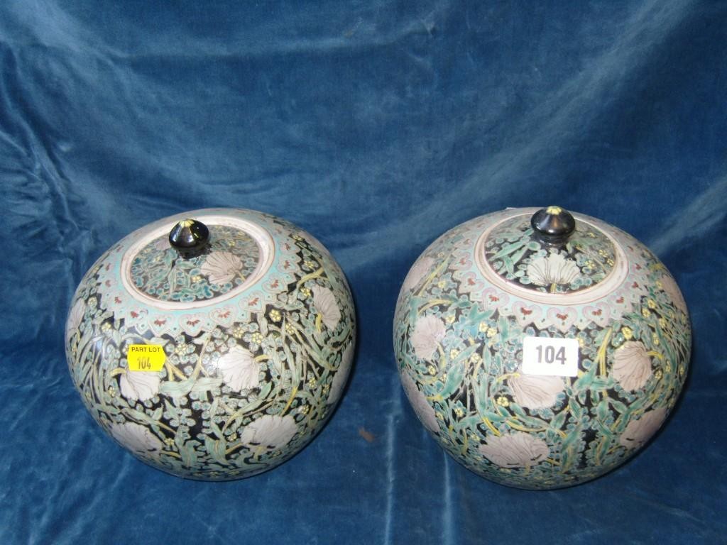 Appraisal: A pair of oriental black ground vases and covers of