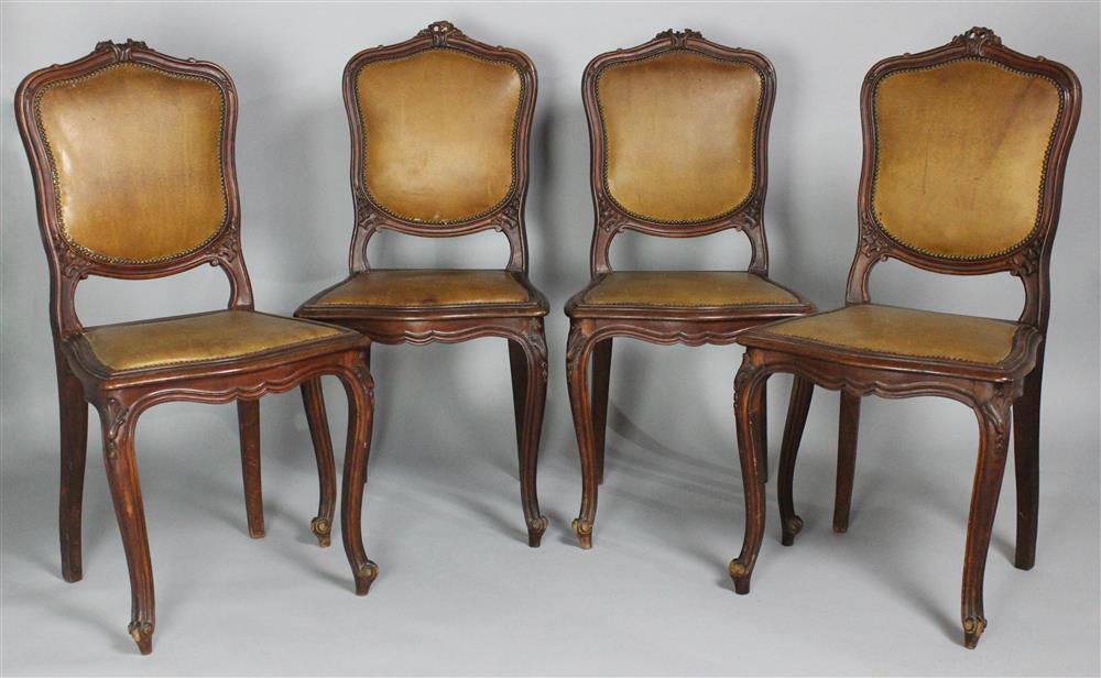 Appraisal: SET OF FOUR CONTINENTAL CHAIRS WITH LEATHER UPHOLSTERY carved crest