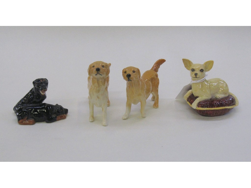 Appraisal: Four Beswick figures of dogs to include two golden retrievers