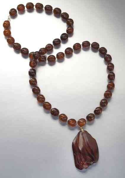 Appraisal: Chinese Qing carved amber necklace ''H Circa - th C