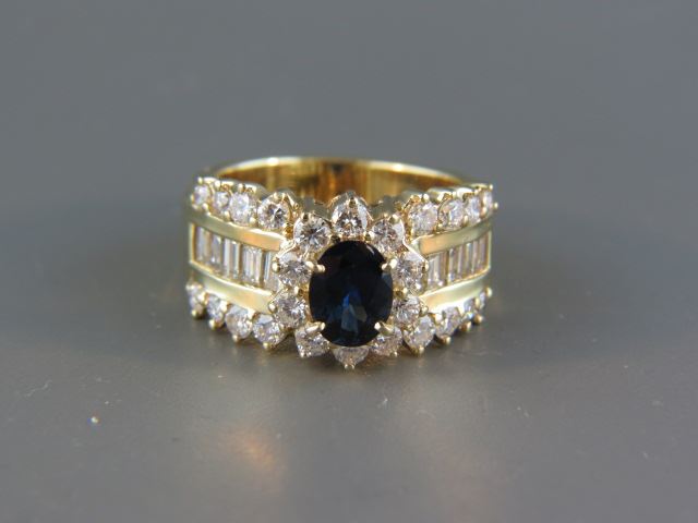 Appraisal: Sapphire Diamond Ring carat deep blue oval gem surrounded by