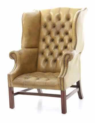 Appraisal: Chippendale style mahogany and leather wingback chair shaped tufted leather