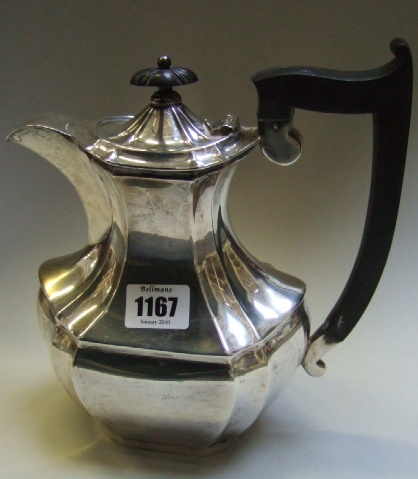 Appraisal: A silver hot water jug of paneled form with a