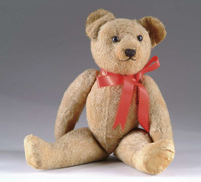 Appraisal: JOINTED GOLDEN TEDDY BEAR Sewn face Teddy has shoe-button eyes