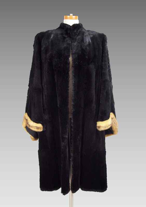 Appraisal: BLACK FUR COAT WITH DRAMATIC MINK CUFFS Full bell sleeves