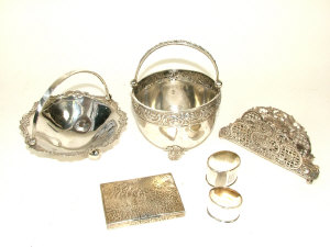 Appraisal: Two Latvian white metal swing handled baskets with foliate scroll