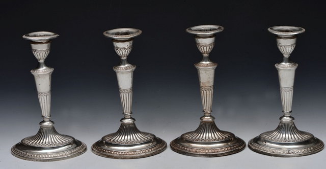 Appraisal: A SET OF FOUR VICTORIAN SILVER CANDLESTICKS standing on an