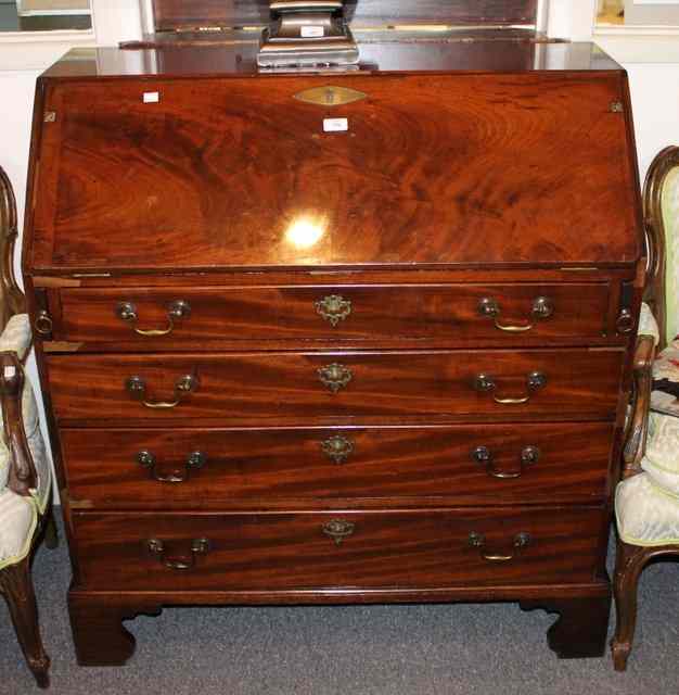 Appraisal: A GEORGIAN MAHOGANY BUREAU the fall front enclosing a fitted