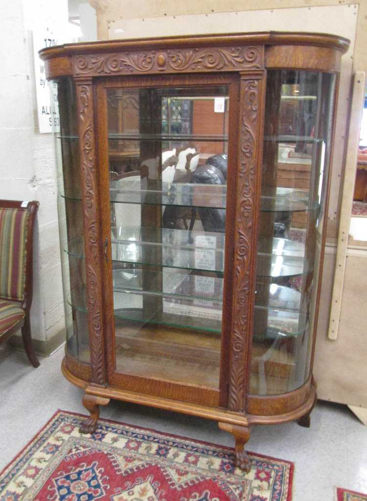 Appraisal: A CARVED OAK AND CURVED GLASS CHINA CABINET American late