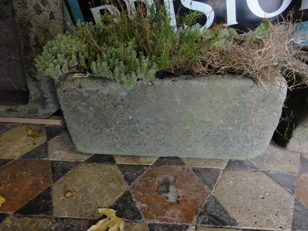 Appraisal: A weathered natural stone garden trough with single 'D' end