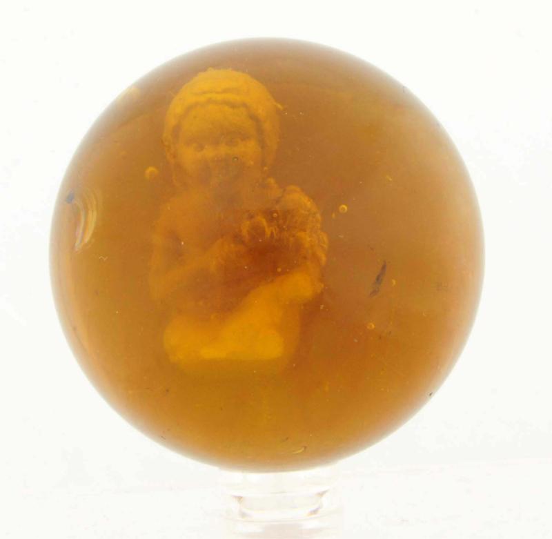 Appraisal: Amber glass base with naked girl with bonnet hat sitting