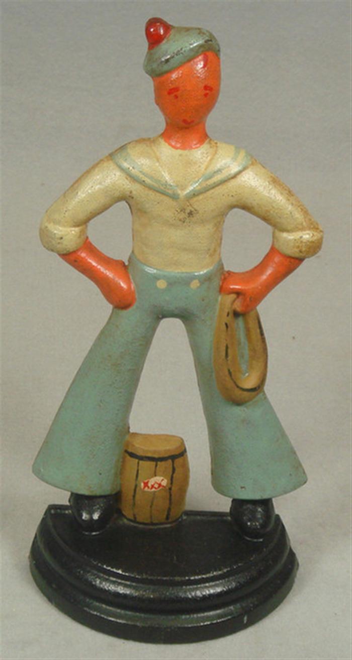 Appraisal: Cast iron doorstop caricature sailor with rope and barrel on