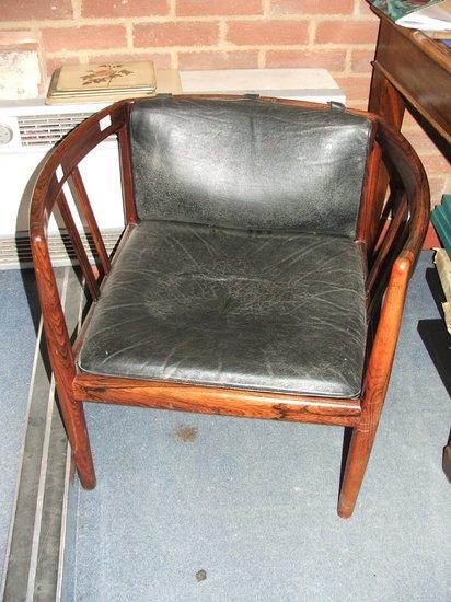 Appraisal: A DANISH ROSEWOOD FRAMED EASY ARMCHAIR with incurving arms above