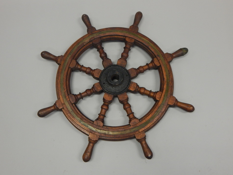 Appraisal: A teak brass and iron ship's wheel lacking maker's mark