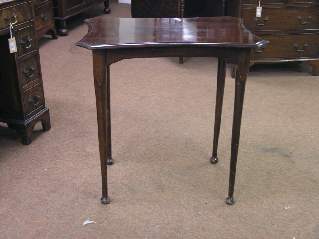 Appraisal: A mahogany occasional table with concave top ft in together