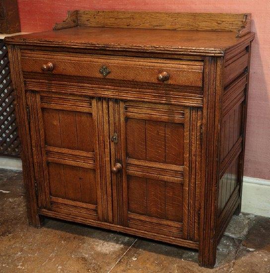 Appraisal: An Arts and Crafts oak dresser with three-quarter galleried top