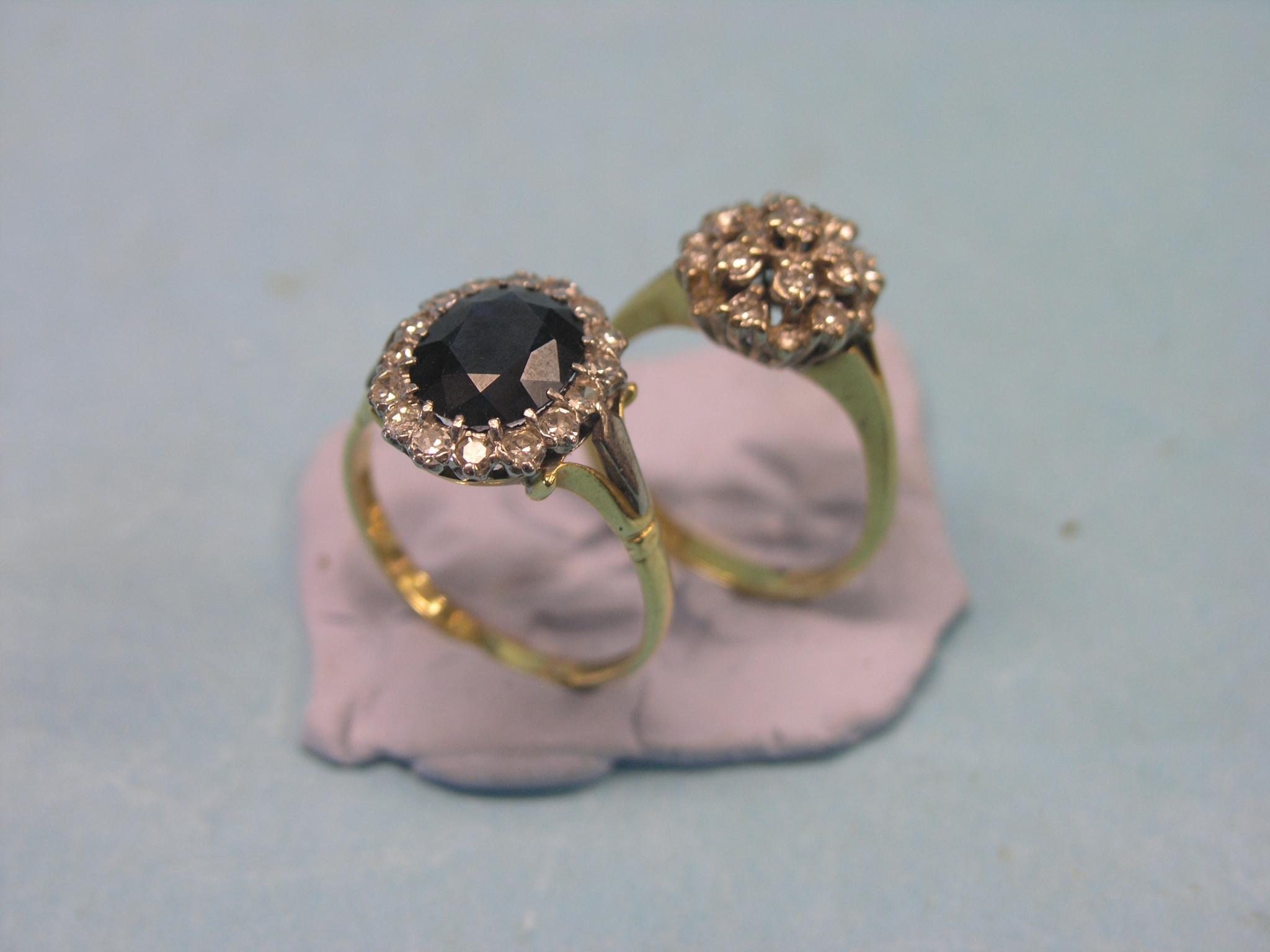 Appraisal: Two ct gold and diamond cluster rings one with central