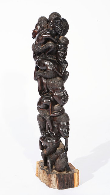 Appraisal: A TALL AFRICAN EBONY CARVED TOTEM TYPE POLE with numerous