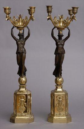 Appraisal: PAIR OF EMPIRE-STYLE BRONZE AND GILT-METAL FOUR-LIGHT CANDELABRA Each winged