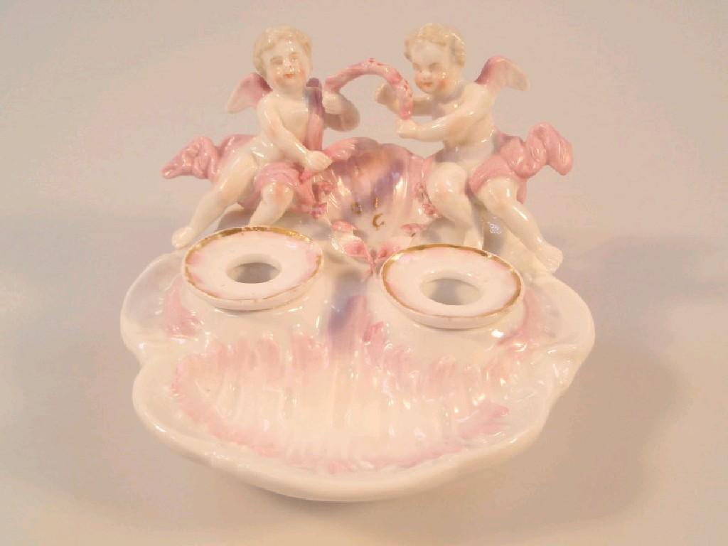 Appraisal: A Continental porcelain encrier with two ink receivers in the