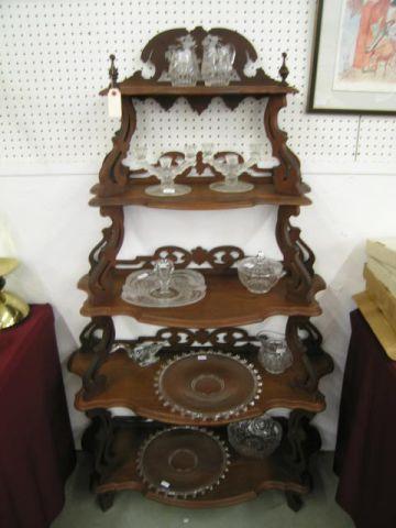 Appraisal: Victorian Walnut Etagere five shelf fancy gingerbread trim