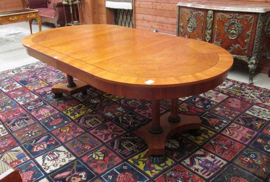 Appraisal: ROUND EMPIRE STYLE DINING TABLE WITH TWO LEAVES Baker Furniture