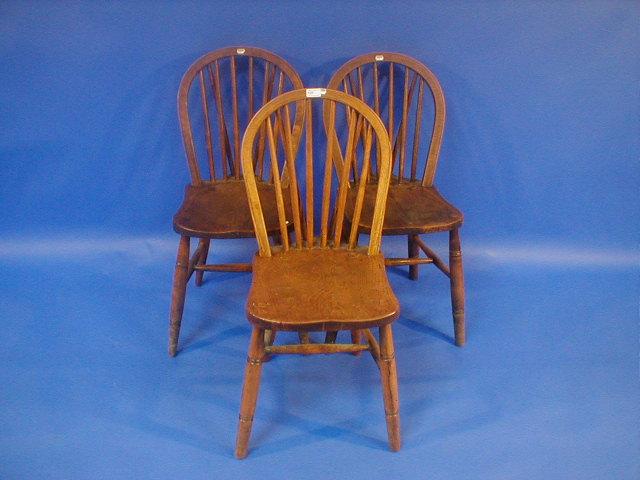 Appraisal: Three thC beech and elm spindle back Windsor side chairs