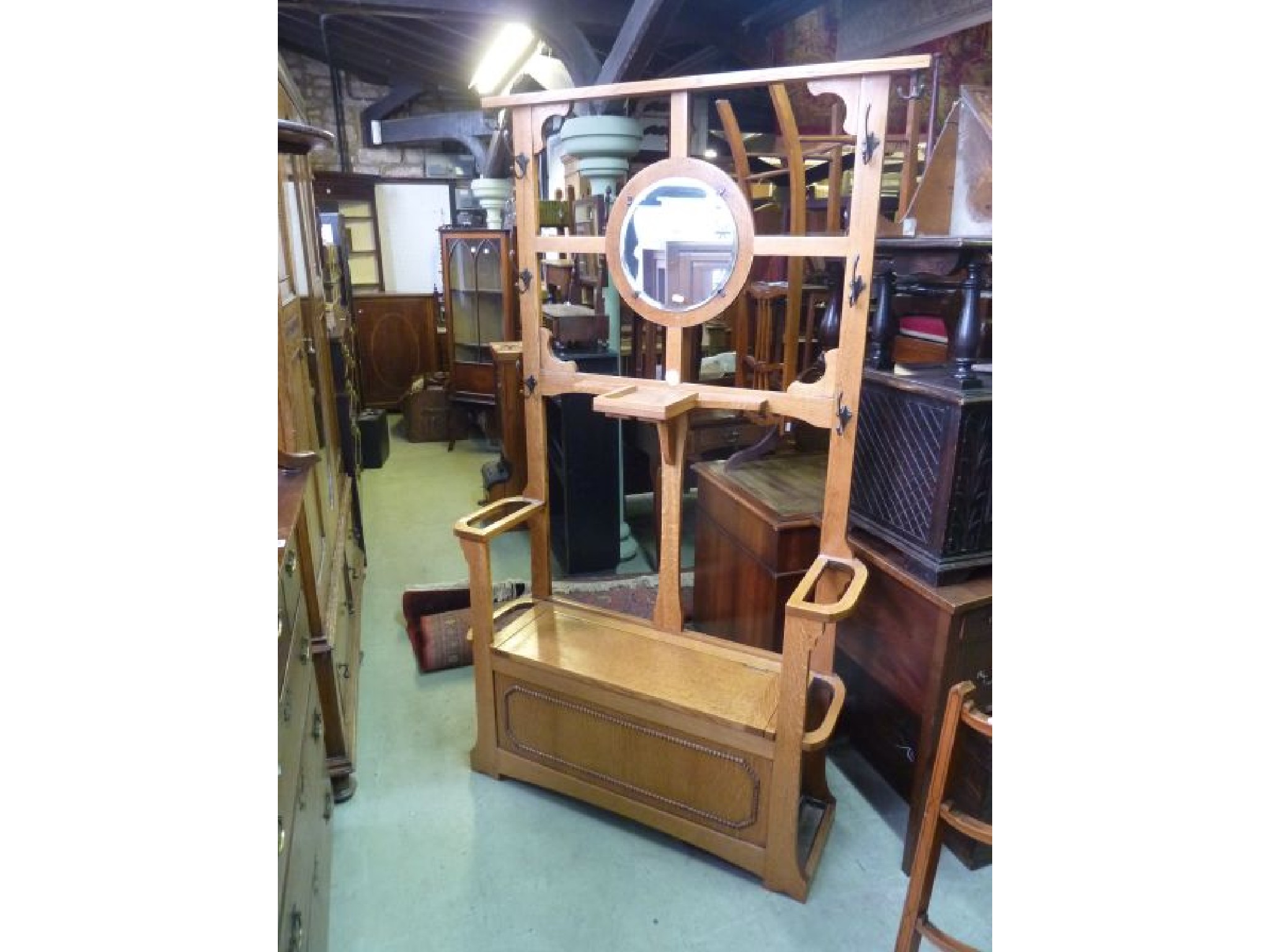 Appraisal: A pale oak hallstand with box seat and central mirror