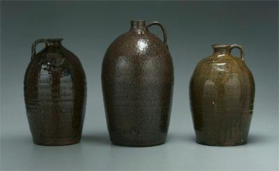 Appraisal: Three alkaline glaze jugs ovoid with fine runny medium brown