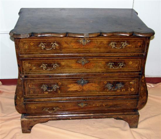 Appraisal: A DUTCH INLAID WALNUT BOMBE CHEST with four long drawers