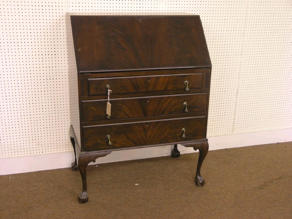 Appraisal: A mahogany bureau feather-veneered fall-front enclosing fittings three drawers beneath