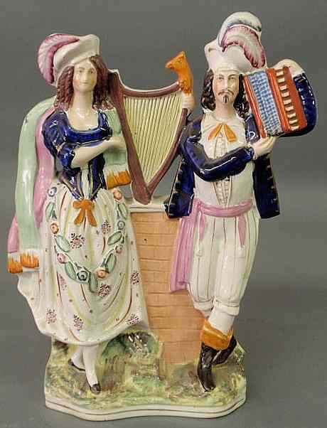 Appraisal: Colorful th c Staffordshire figural group of a woman with