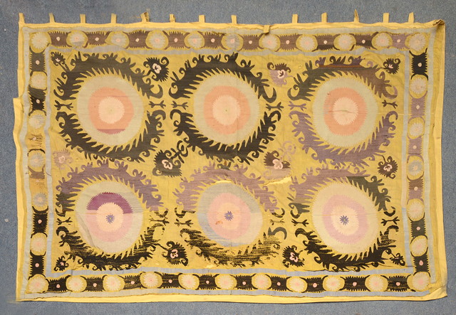 Appraisal: AN UZBEK YELLOW GROUND SUSANI WALL HANGING decorated two rows