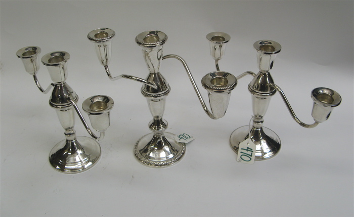 Appraisal: GROUP OF THREE AMERICAN STERLING SILVER THREE-LIGHT CANDELABRA Two are