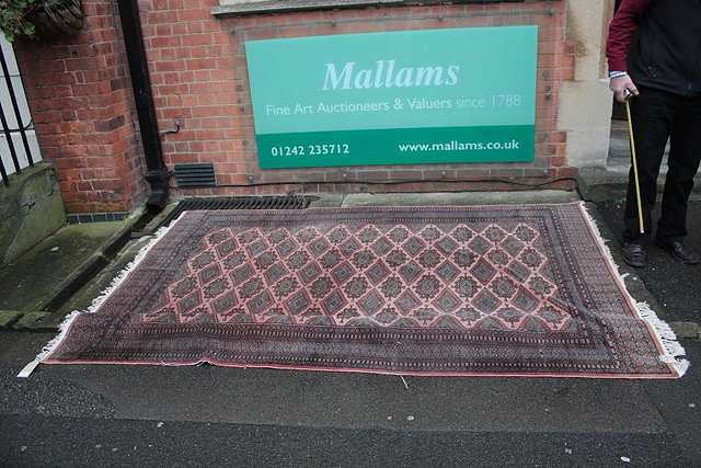 Appraisal: AN AFGHAN BOKHARA STYLE RUG with rows of medallions cm