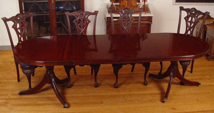 Appraisal: OVAL DOUBLE PEDESTAL BANDED MAHOGANY DINING TABLE Splayed legs Two