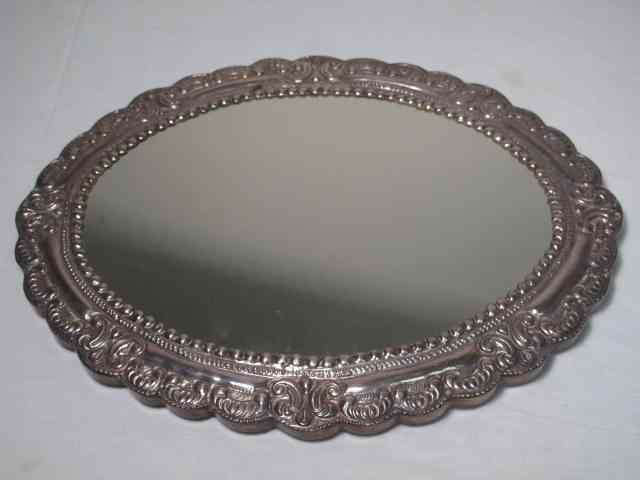 Appraisal: An oval mirrored plateau with sterling silver repousse rim Wood