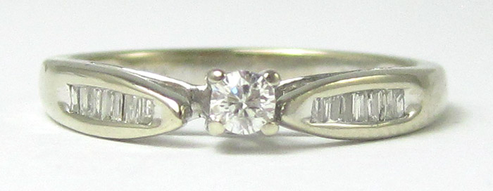 Appraisal: DIAMOND AND TEN KARAT WHITE GOLD RING having channel set