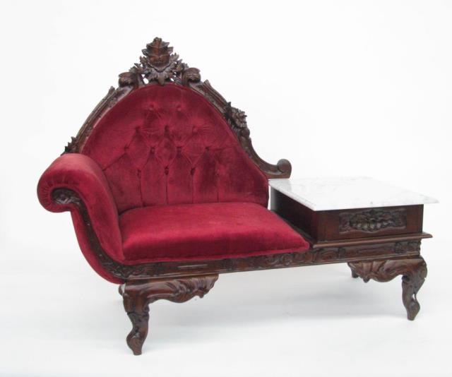 Appraisal: A two piece carved mahogany parlor suite including settee and