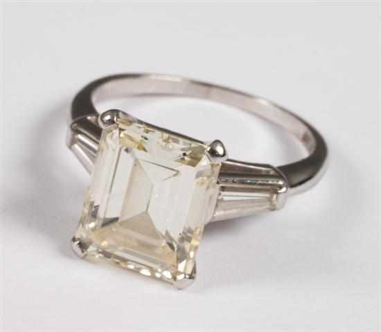 Appraisal: Approximately cts diamond emerald-cut ring set into platinum flanked by