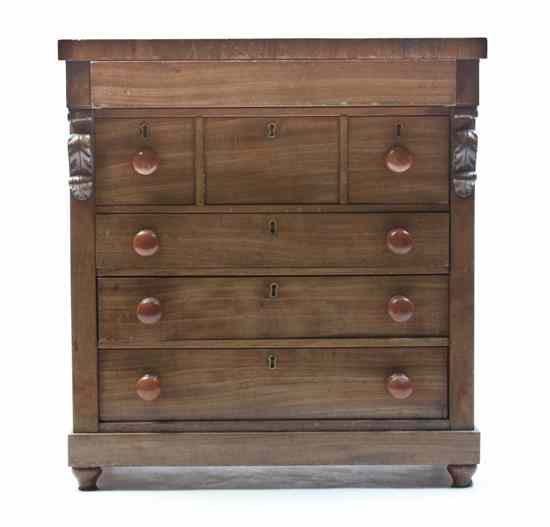 Appraisal: A Diminutive Walnut Chest of Drawers set with a deep