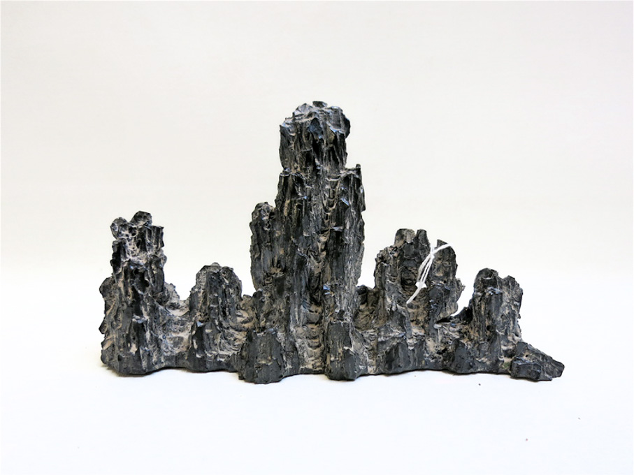 Appraisal: CHINESE PORCELAIN BRUSH REST a black glazed porcelain mountain crag