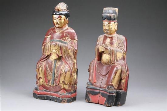 Appraisal: TWO PAINTED WOOD FIGURES Oriental style figures of seated men