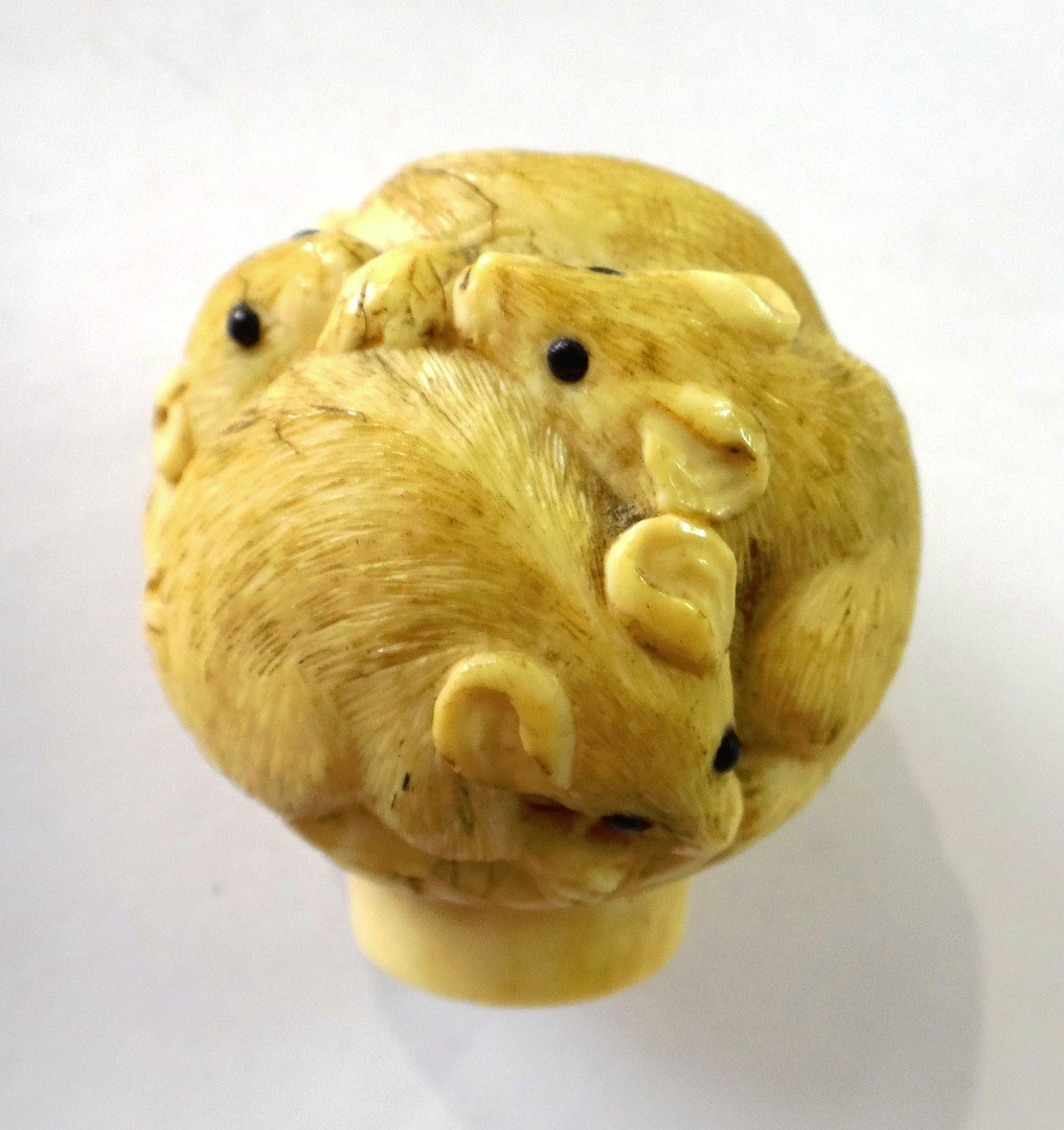 Appraisal: A Japanese ivory pommel Meiji period carved with rats with