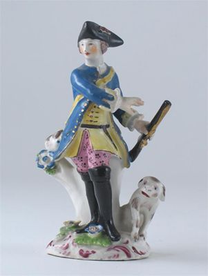 Appraisal: A Bow figure of a sportsman holding a gun in