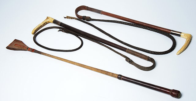 Appraisal: TWO OLD ANTLER AND LEATHER WHIPS with silver mounts and