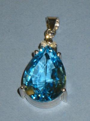 Appraisal: A TOPAZ AND DIAMOND PENDANT the pear cut topaz claw